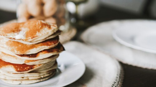 A stack of pancakes sitting on top of a white plate