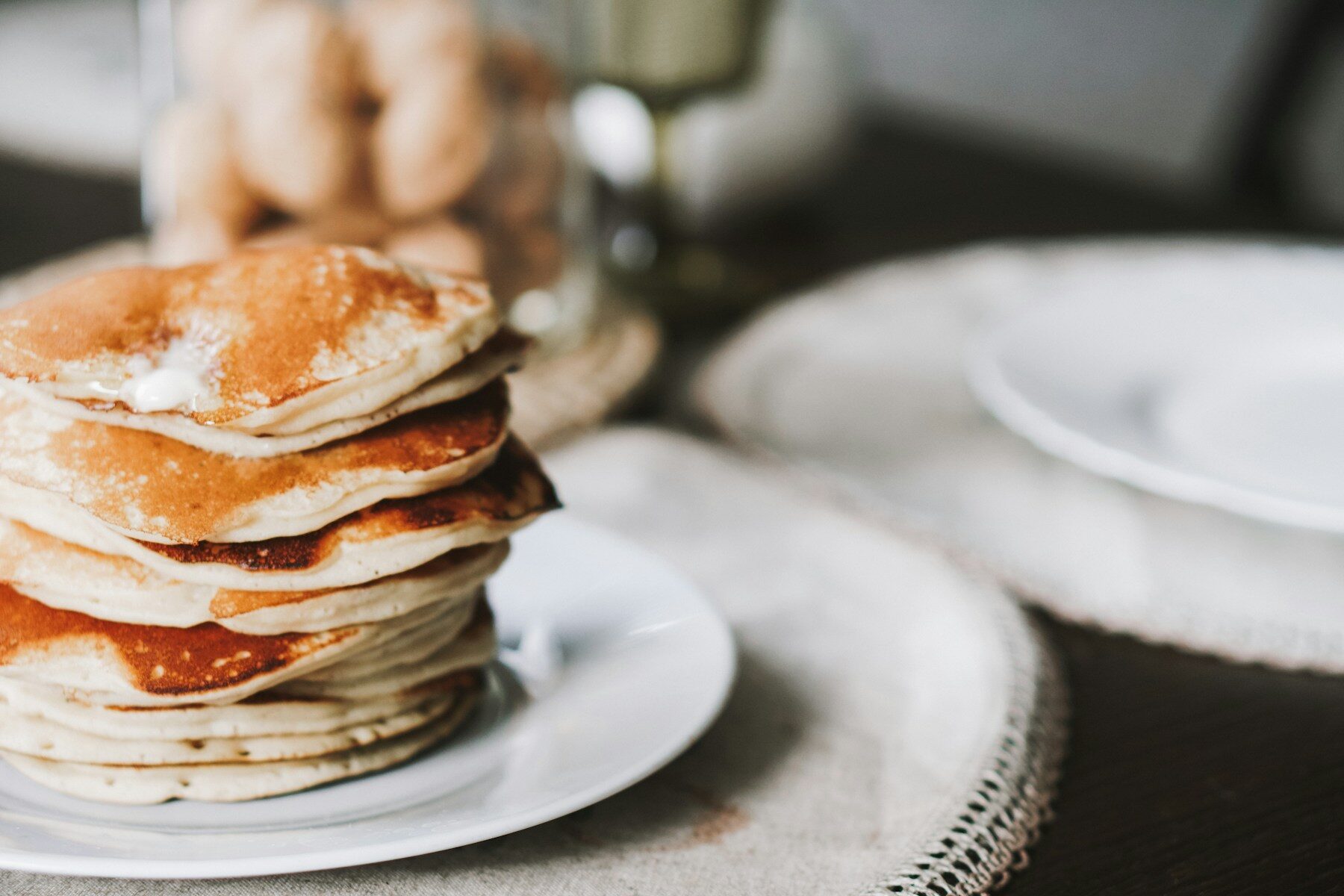 A stack of pancakes sitting on top of a white plate