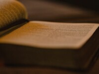an open book sitting on top of a wooden table