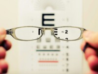 person holding eyeglasses