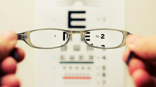 person holding eyeglasses